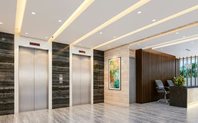 Hall d’entrée de bureaux avec ascenseurs et grand sol carrelé